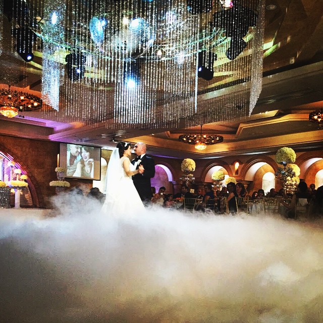 Great example of the goodies that you can only get in an indoor wedding: smoke effects, gorgeous chandeliers and video screens. These all add to the elements of luxurious celebration and fun!Source: Anoush.com